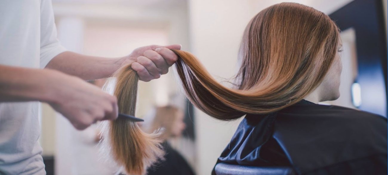 Stylist working on a client's colour in a salon